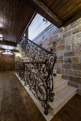 Decorative wrought iron on staircases with stone wall