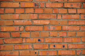 The texture of an old wheatered red brick wall, background