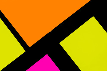 Yellow, orange and purple hue colorful office stickers on black paper. Office noteparer as...