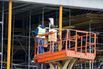 Large construction site with new construction machinery and workers 