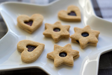 Christmas sweets and cookies made from shortcrust pastry, various shapes filled with marmalade and decorated with chocolate
