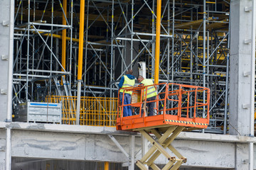Large construction site with new construction machinery and workers 