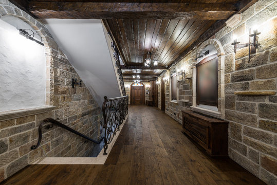 Brick Stone Wall And Wooden Ceiling In Luxury Mansion Hallway