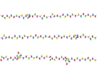 Christmas glowing lights on white background. Garlands with colored bulbs. Xmas holidays. Christmas greeting card design element. New year,winter.