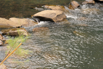 The waterfall flows through the rocks into small streams.