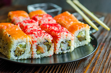 two types of sushi rolls with flying fish roe