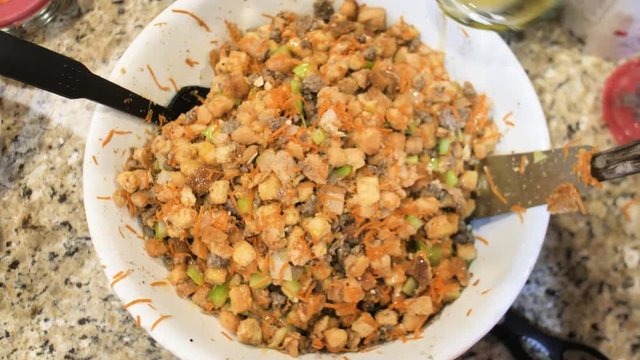 Thanksgiving Stuffing Bowl Adding Butter And Stirring Ingredients In Kitchen Celery Carrot Onion Bread Nut