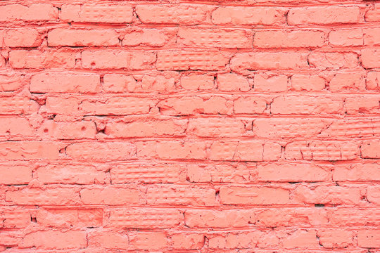 Painted vintage grunge brick wall texture, coral color, trendy urban background. Horizontal texture. For banner design