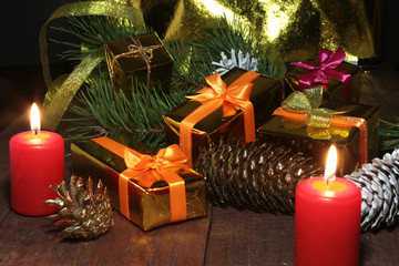 Christmas tree and cones, New Year's colorful balls with ribbon and gift box on wood background. Decoration for happy holidays. Copy space.