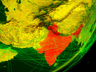 India on green model of planet Earth with network at night. Concept of digital technology, communication and travel.