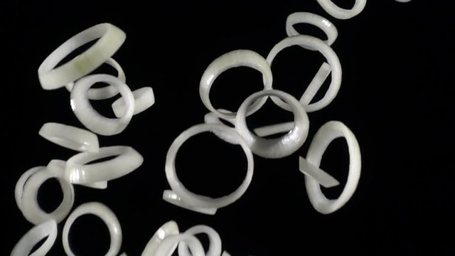 Falling rings of onion slices, slow motion
