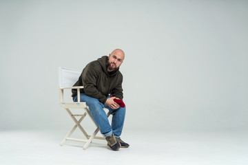 male casting director sitting on a folding chair