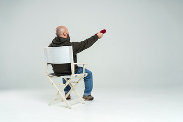 male casting director sitting on a folding chair