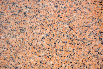 Orange granite stone background. Black, gray and orange colored granite texture.