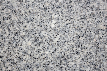 Spotted granite stone background. Black, gray and white colored granite texture.