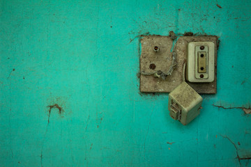 Old electrical outlet in disuse. Old wall.