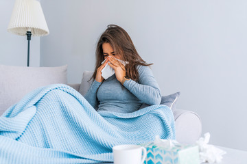 Sick Woman.Flu.Woman Caught Cold. Sneezing into Tissue. Headache. Virus .Medicines