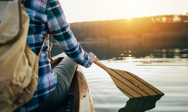 Rear view of canoeist holding canoe oar