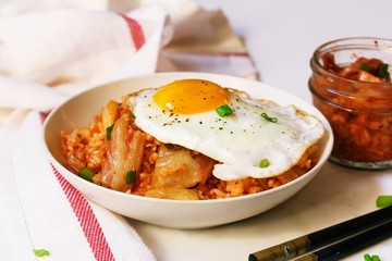 Homemade Kimchi fried rice topped with fried egg, selective focus