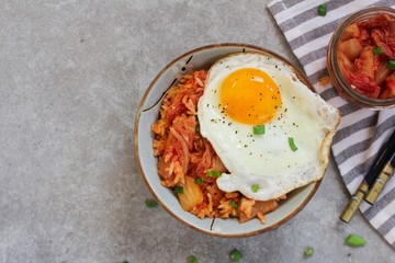 Homemade Kimchi fried rice topped with fried egg, selective focus