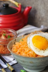 Homemade Kimchi fried rice topped with fried egg, selective focus