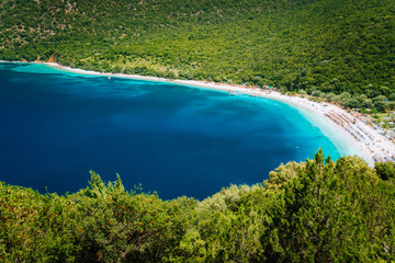 Sunny summer day on Antisamos beach on Kefalonia island, Greece. Crystal clear water, huge hills beautiful white beach, picturesque nature. Stunning view of mediterranean coastline