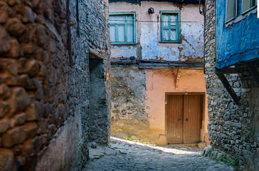 Fototapeta na wymiar Abandoned house on a narrow street in Cumalikizik, Bursa, Turkey
