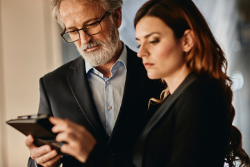 Co-workers discussing an important matter on a empty hallway. 