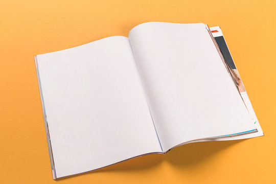 opened magazine mock-up on orange background