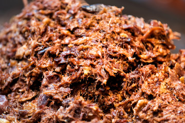 Shish kabob shredded pork barbeque bbq meat large beef pile in fast food truck counter showing macro closeup detail texture, red orange brown fresh color, pattern