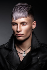 Obraz premium Young man with purple hair and creative makeup and hair.