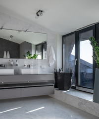 Sunny bathroom in modern style with light walls