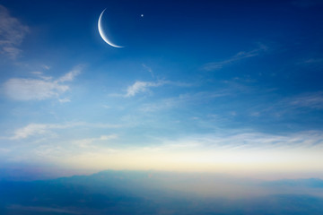   new moon .  Prayer time . Generous Ramadan .  Mubarak background . Glowing sunset . Sunset or sunrise with clouds . The sky at night with stars. Crescent moon with beautiful sunset background . 