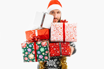 man holds a lot of Christmas gifts in the Studio on a white background, choose a gift