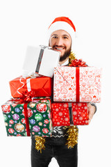 man holds a lot of Christmas gifts in the Studio on a white background, choose a gift