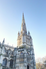 The Gothic and Reinassance Saint Mary Redcliffe Church bell tower with pointed roof and steeples, during a sunny winter day in Bristol, United Kingdom