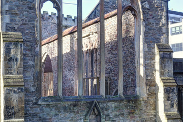 Gothic pointed arch windows on a stone wall without roof in the abandoned rumbled Temple Church in Bristol, in a sunny winter day, in United Kingdom
