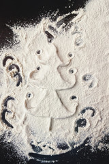 Christmas tree with confetti in flour prepared of white dough