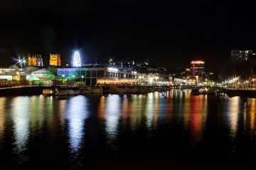 The Bristol Cathedral and wharf on the Avon river from Museum promenade in Spike Island, by night, with some boats, United Kingdom