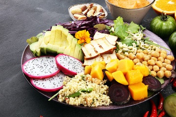 grilled tofu and dragon fruit buddha bowl with vegetable and humus
