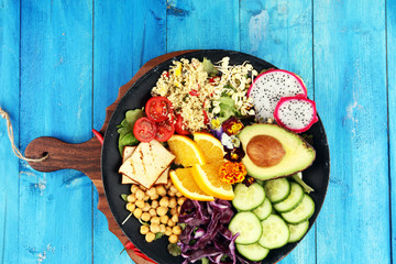 grilled tofu and dragon fruit buddha bowl with vegetable and humus
