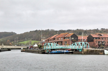 The Junction Lock turning metal bridge over the Avon river wharf, during a cloudy winter day, in Bristol, United Kingdom