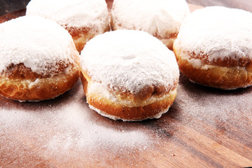 German donuts with jam and icing sugar. Carnival powdered sugar raised donuts