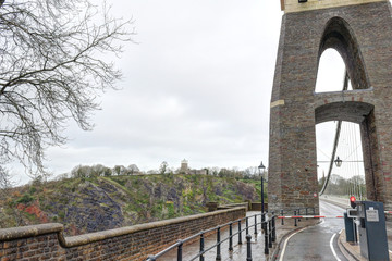 Fototapeta premium A detail of the tower at the entrance of the Clifton suspension bridge in a cloudy winter day in Bristol, United Kingdom