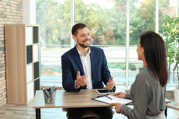 Human resources manager conducting job interview with applicant in office