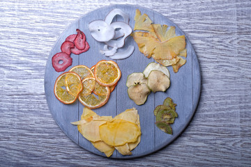 Dried fruits in wooden tray on gray wooden background