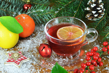 Christmas tea in transparent cup and Christmas decoration