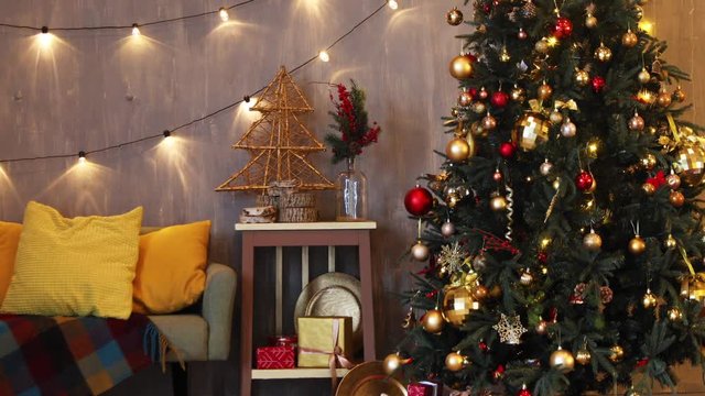 Funny colorful room with christmas interior, Xmas Tree decorated. Color decor with sofa and pillows
