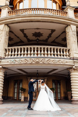 portrait of the bride and groom near the building, a couple in love