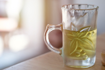 Cold Green tea in a glass on wooden floor. Health benefits have the ability to resist the disease, It is popular with most thai people.